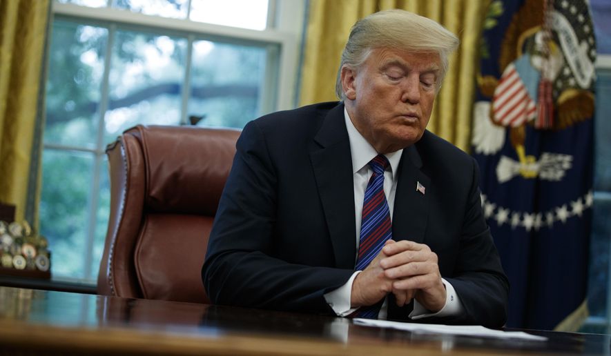 In this Aug. 27, 2018, photo, President Donald Trump talks on the phone with Mexican President Enrique Pena Nieto, in the Oval Office of the White House in Washington. (AP Photo/Evan Vucci)