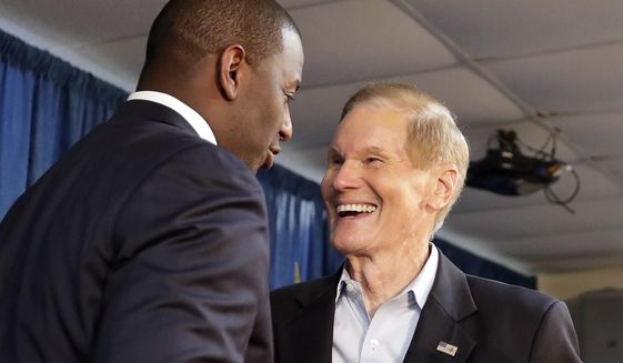Florida Democratic gubernatorial candidate Andrew Gillum, left, greets Sen. Bill Nelson, D-Fla. before speaking to supporters at a Democratic Party rally Friday, Aug. 31, 2018, in Orlando, Fla. (AP Photo/John Raoux)