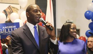 FILE - In this Aug. 28, 2018, file photo, Andrew Gillum and his wife, R. Jai Gillum, address supporters in Tallahassee, Fla. Gillum defeated former U.S. Rep. Gwen Graham and four other candidates. Republicans are taking aim at his tenure as mayor of Tallahassee, including an ongoing FBI investigation into City Hall, that Gillum claims he is not a target. Gillum will face GOP gubernatorial nominee Congressman Ron DeSantis. (AP Photo/Steve Cannon, File)
