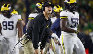 Michigan head coach Jim Harbaugh watches a replay in the first half of an NCAA football game against Notre Dame in South Bend, Ind., Saturday, Sept. 1, 2018. (AP Photo/Paul Sancya)