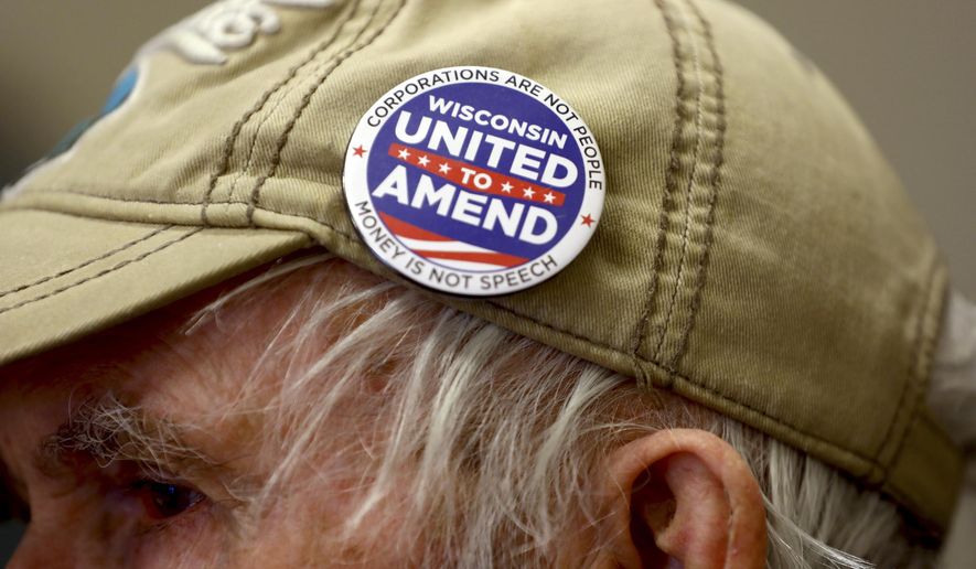 In this April 10, 2018, photo provided by the Wisconsin Center for Investigative Journalism, John Coover attends a meeting of the South Central Wisconsin United to Amend group at the Sequoya Library in Madison, Wis. The nonpartisan citizens group is part of a nationwide movement seeking to impose restrictions on campaign contributions. (Coburn Dukehart/Wisconsin Center for Investigative Journalism via AP)