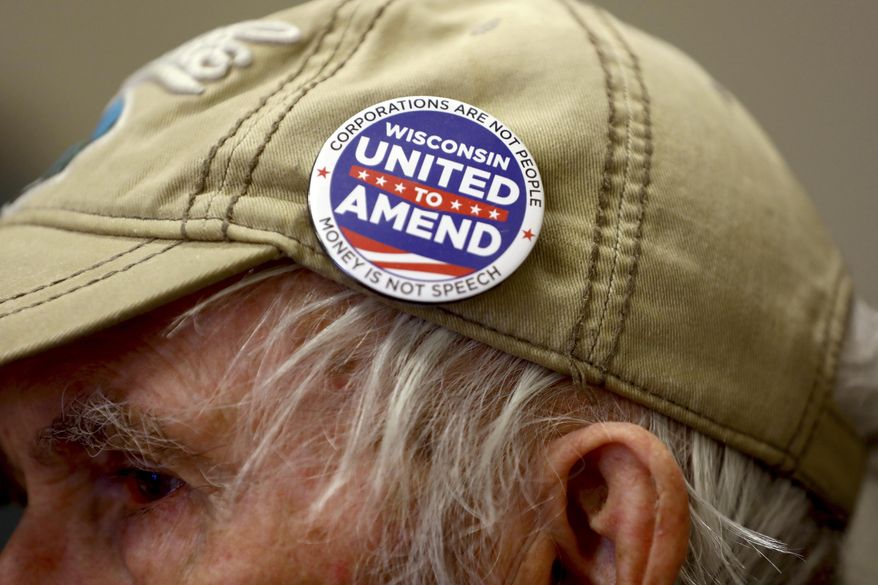 In this April 10, 2018, photo provided by the Wisconsin Center for Investigative Journalism, John Coover attends a meeting of the South Central Wisconsin United to Amend group at the Sequoya Library in Madison, Wis. The nonpartisan citizens group is part of a nationwide movement seeking to impose restrictions on campaign contributions. (Coburn Dukehart/Wisconsin Center for Investigative Journalism via AP)