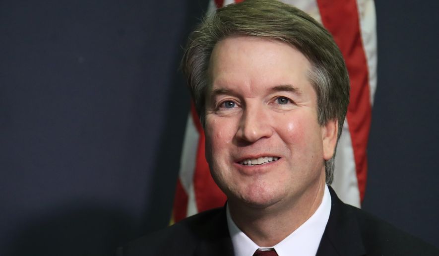 FILE - In this July 19, 2018, file photo, Supreme Court nominee Brett Kavanaugh glances at reporters during a meeting with Sen. James Lankford, R-Okla., on Capitol Hill in Washington. Kavanaugh has been a conservative team player, and the Supreme Court nominee has stepped up to make a play at key moments in politics, government and the law dating to the Bill Clinton era.  (AP Photo/Manuel Balce Ceneta, File)