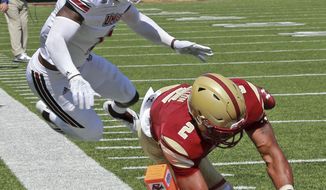 Boston College running back AJ Dillon (2) dives in for the touchdown as Massachusetts safety Brice McAllister (2) flies over him during an NCAA college football game, Saturday, Sept. 1, 2018, in Boston. (Stuart Cahill/The Boston Herald via AP)