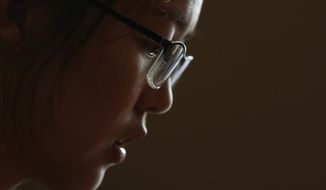 In this July 3, 2018, photo, Ren Liping pauses during an interview after filing her petition to have her rape allegation case reexamined in Beijing. Chinese graduate student Ren has spent the past year filing lawsuits and attempting to protest authorities in the coastal city of Qingdao for what she says was their mishandling of her rape allegation. At every turn, Ren has been stymied by guards. Her efforts highlight at once the challenges of reporting sexual assault in China and the determination of a new generation of Chinese women pushing the country into its own #MeToo moment despite all attempts to silence them. (AP Photo/Andy Wong)