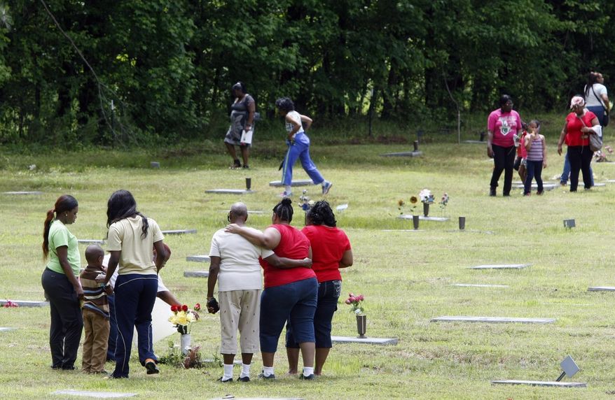 FILE - In this May 25, 2015, file photo, people visit the Galilee Memorial Gardens cemetery near Memphis, Tenn. The Tennessee cemetery where caskets were crushed and stacked, remains were mishandled and bodies were lost, remains closed. But the dispute about who is to blame for the problems at the burial ground is still alive. Opening statements are scheduled Tuesday, Sept. 4, 2018, in the trial pitting relatives of about 1,200 dead people against funeral homes accused of sending bodies to Galilee after the cemetery lost its registration in December 2010. (AP Photo/Karen Pulfer Focht, File)