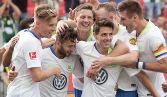 FILE -- In this Saturday, Sept. 1, 2018 photo Wolfsburg&#39;s players celebrate their side&#39;s 3rd goal during the German Bundesliga soccer match between Bayer 04 Leverkusen and VfL Wolfsburg in Leverkusen, Germany. Wolfsburg is bucking expectations after starting the Bundesliga with two wins over highly rated Schalke and Bayer Leverkusen. (Federico Gambarini/dpa via AP)