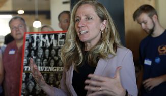 Former CIA officer and Democratic candidate for the 7th district Congressional seat, Abigail Spanberger, center, speaks to supporters at a rally in Richmond, Va., Wednesday, July 18, 2018.  Opposition to President Donald Trump is changing the political map for Democrats who find themselves riding a wave of anti-Trump energy to compete in areas they once left for lost.  (AP Photo/Steve Helber)