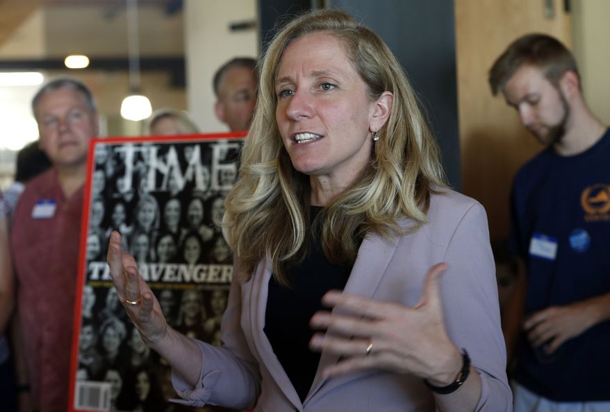 Former CIA officer and Democratic candidate for the 7th district Congressional seat, Abigail Spanberger, center, speaks to supporters at a rally in Richmond, Va., Wednesday, July 18, 2018.  Opposition to President Donald Trump is changing the political map for Democrats who find themselves riding a wave of anti-Trump energy to compete in areas they once left for lost.  (AP Photo/Steve Helber)