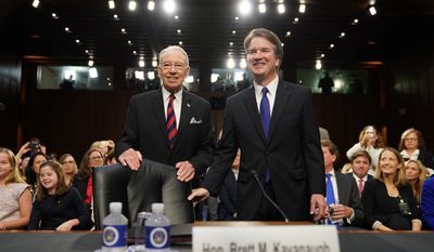 Supreme Court nominee Brett Kavanaugh, standing with Senate Judiciary Chairman Chuck Grassley, R-Iowa,  arrives at the Senate Judiciary Committee on Capitol Hill, Tuesday, Sept. 4, 2018, in Washington, to begin his confirmation hearing to replace retired Justice Anthony Kennedy. (AP Photo/Andrew Harnik)