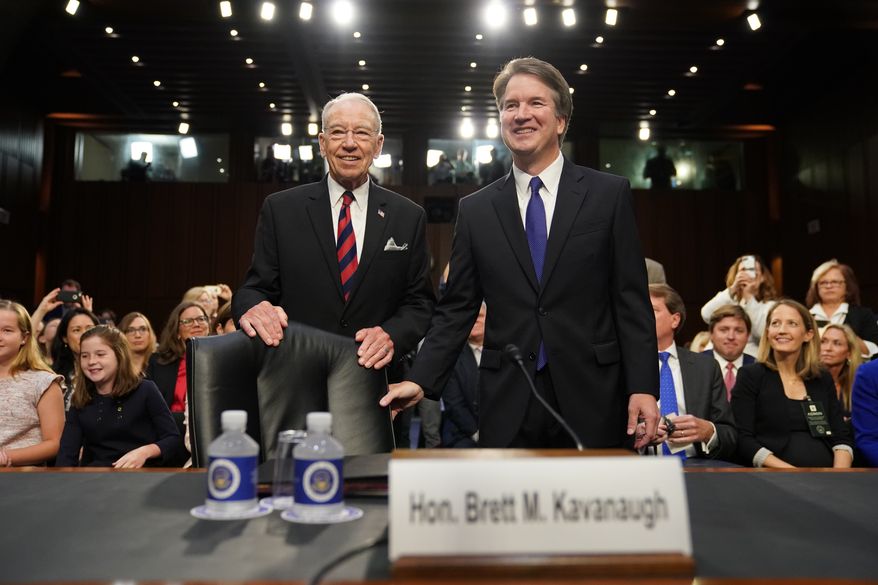 Supreme Court nominee Brett Kavanaugh, standing with Senate Judiciary Chairman Chuck Grassley, R-Iowa,  arrives at the Senate Judiciary Committee on Capitol Hill, Tuesday, Sept. 4, 2018, in Washington, to begin his confirmation hearing to replace retired Justice Anthony Kennedy. (AP Photo/Andrew Harnik)