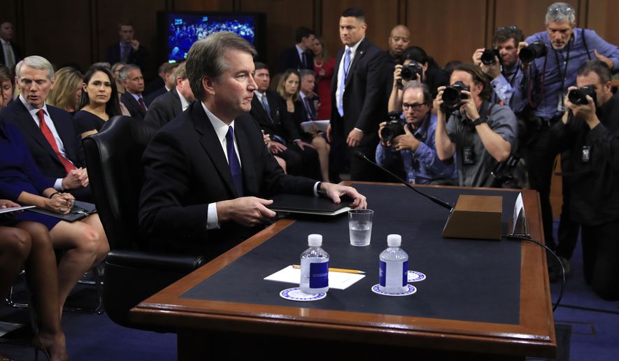 Supreme Court nominee Brett Kavanaugh, listens to Senate Judiciary Committee Chairman Sen. Chuck Grassley, R-Iowa, after giving his opening statement during the committee&#39;s nominations hearing on Capitol Hill in Washington, Tuesday, Sept. 4, 2018. Former Secretary of State Condoleezza Rice is seated back left. (AP Photo/Manuel Balce Ceneta)