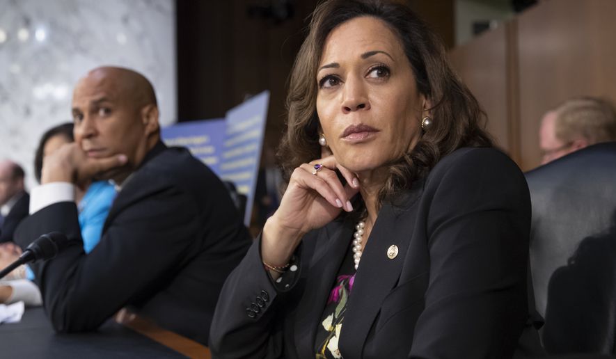 Sen. Kamala Harris, D-Calif., and Sen. Cory Booker, D-N.J., left, pause as protesters disrupt the confirmation hearing of President Donald Trump&#39;s Supreme Court nominee, Brett Kavanaugh, on Capitol Hill in Washington, Tuesday, Sept. 4, 2018. (AP Photo/J. Scott Applewhite)