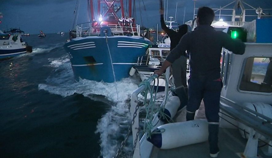 In this image taken from France 3 video, French and British boats clash off France's northern coast, early Tuesday Aug. 28, 2018. French maritime authorities are appealing for calm after fishermen from rival French and British fleets banged their boats in ill-tempered skirmishes over access to the scallop-rich waters off France's northern coast. (France 3 via AP)