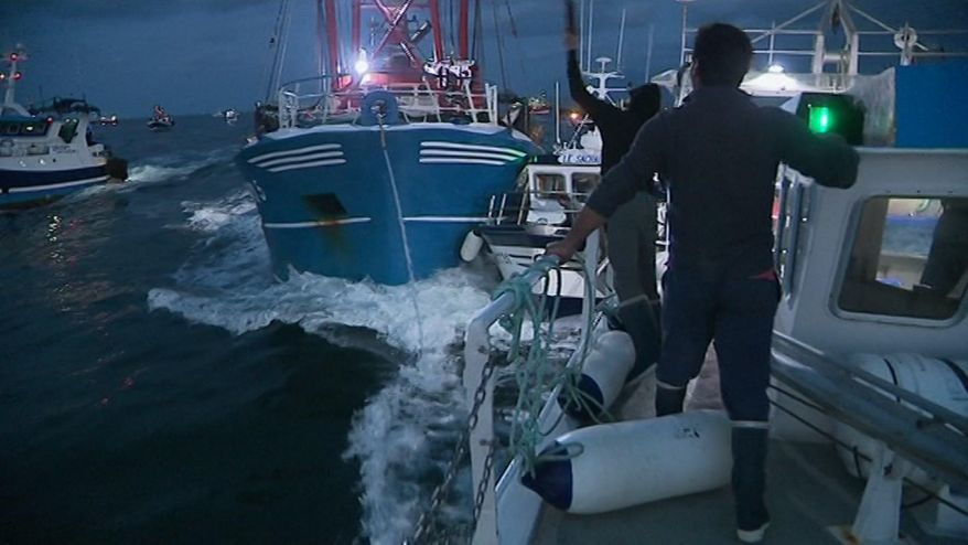 In this image taken from France 3 video, French and British boats clash off France's northern coast, early Tuesday Aug. 28, 2018. French maritime authorities are appealing for calm after fishermen from rival French and British fleets banged their boats in ill-tempered skirmishes over access to the scallop-rich waters off France's northern coast. (France 3 via AP)