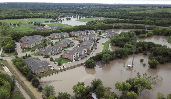 This Monday, Sept. 3, 2018, aerial photo taken with a drone and provided by the Riley County Department shows flooding near a residential area in Manhattan, Kan. Heavy rain caused a creek to burst its banks and flood the Kansas college town, forcing more than 300 people to evacuate their homes, including some who were ferried to dry land in boats. (Doug Wood/Riley County Police Department via AP)