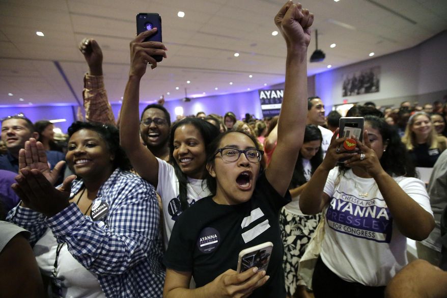 Jocelyn Antonio, of Quincy, Mass., center, a supporter of Boston City Councilor Ayanna Pressley, celebrates Pressley's victory over U.S. Rep. Michael Capuano, D-Mass., in the 7th Congressional House Democratic primary, Tuesday, Sept. 4, 2018, in Boston. (AP Photo/Steven Senne)