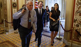 FILE - In this July 11, 2018, file photo, Supreme Court nominee Brett Kavanaugh is escorted by former Sen. Jon Kyl, R-Ariz., to a meeting on Capitol Hill in Washington. Sen. John McCain&#39;s widow on Tuesday, Sept. 4, 2018, said Kyl will fill her late husband&#39;s seat. (AP Photo/Evan Vucci, File)