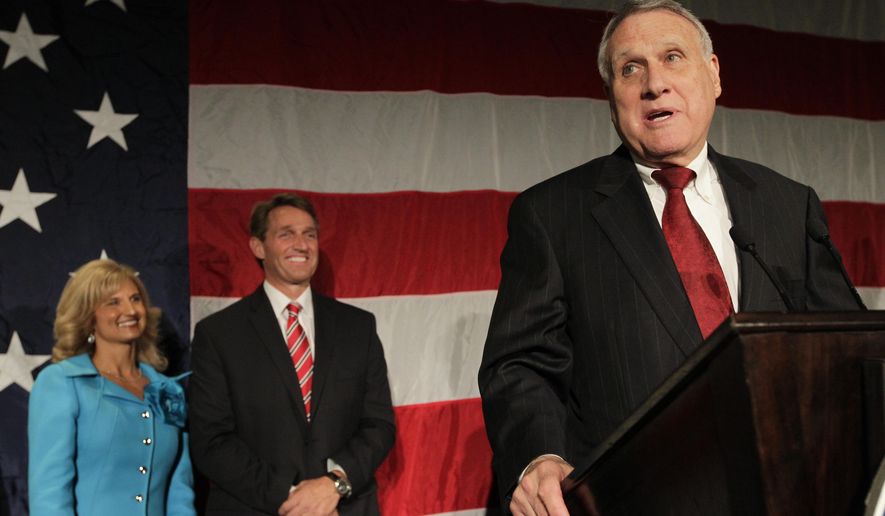 FILE - In this Nov. 6, 2012, file photo, U.S. Sen Jon Kyl, right, introduces U.S. Rep. Jeff Flake, R-Ariz., during an election night party, at a hotel in Phoenix. At left is Flake&#x27;s wife, Cheryl Flake. Sen. John McCain&#x27;s widow on Tuesday, Sept. 4, 2018, said Kyl will fill her late husband&#x27;s seat. (AP Photo/Matt York)
