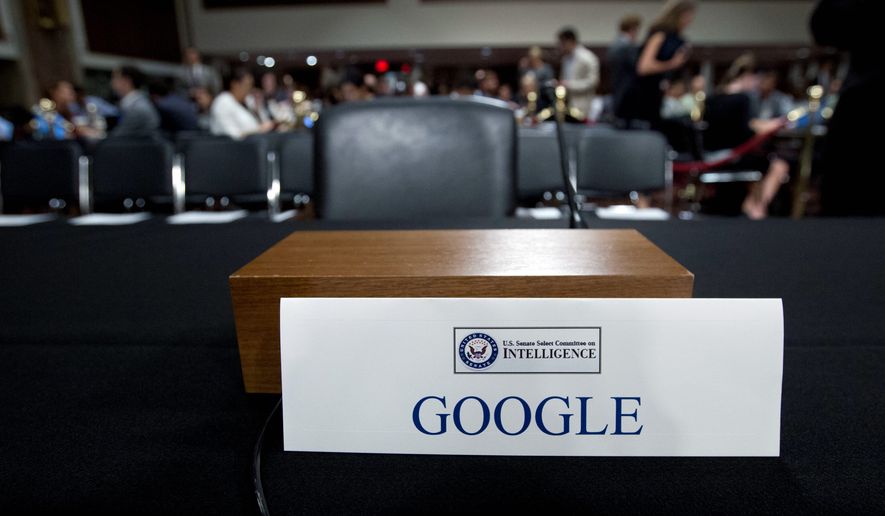 An empty chair reserved for Google's parent Alphabet, which refused to send its top executive, is seen as Facebook COO Sheryl Sandberg accompanied by Twitter CEO Jack Dorsey testify before the Senate Intelligence Committee hearing on 'Foreign Influence Operations and Their Use of Social Media Platforms' on Capitol Hill, Wednesday, Sept. 5, 2018, in Washington. Google CEO did not show for the hearing. (AP Photo/Jose Luis Magana)