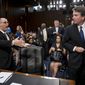 Fred Guttenberg, the father of Jamie Guttenberg who was killing in the Stoneman Douglas High School shooting in Parkland, Fla., left, attempts to shake hands with President Donald Trump&#39;s Supreme Court nominee, Brett Kavanaugh, a federal appeals court judge, right, as he leaves for a lunch break while appearing before the Senate Judiciary Committee on Capitol Hill in Washington, Tuesday, Sept. 4, 2018, to begin his confirmation to replace retired Justice Anthony Kennedy. Kavanaugh did not shake his hand. (AP Photo/Andrew Harnik)