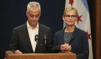 With wife Amy Rule by his side, Chicago Mayor Rahm Emanuel announces Tuesday, Sept. 4, 2018, he will not seek a third term in office at a press conference on the 5th floor at City Hall in Chicago. (Stacey Wescott/Chicago Tribune via AP)