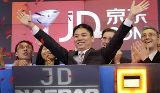 FILE - In this file photo taken Thursday, May 22, 2014, Liu Qiangdong, also known as Richard Liu, CEO of JD.com, raises his arms to celebrate the IPO for his company at the Nasdaq MarketSite, in New York. JD.com, China&#39;s No. 2 e-commerce service, is headquartered in Beijing. The Chinese e-commerce billionaire who faces a possible rape accusation in Minneapolis built his business by promising honesty in a market plagued by fraud and fakes. (AP Photo/Mark Lennihan, File)