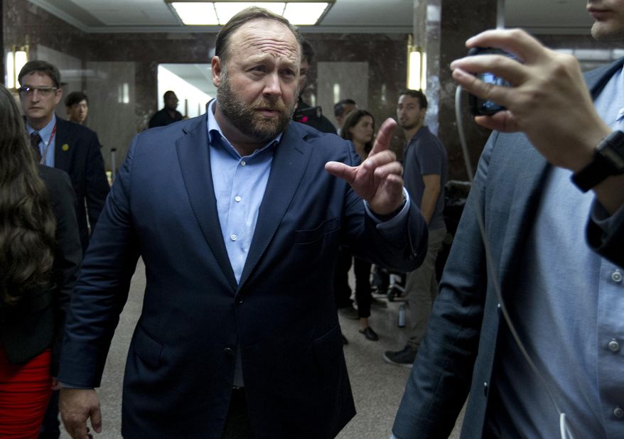 Alex Jones, the right-wing conspiracy theorist, walks the corridors of Capitol Hill after listening to Facebook COO Sheryl Sandberg and Twitter CEO Jack Dorsey testify before the Senate Intelligence Committee on 'Foreign Influence Operations and Their Use of Social Media Platforms' on Capitol Hill, Wednesday, Sept. 5, 2018, in Washington. (AP Photo/Jose Luis Magana)