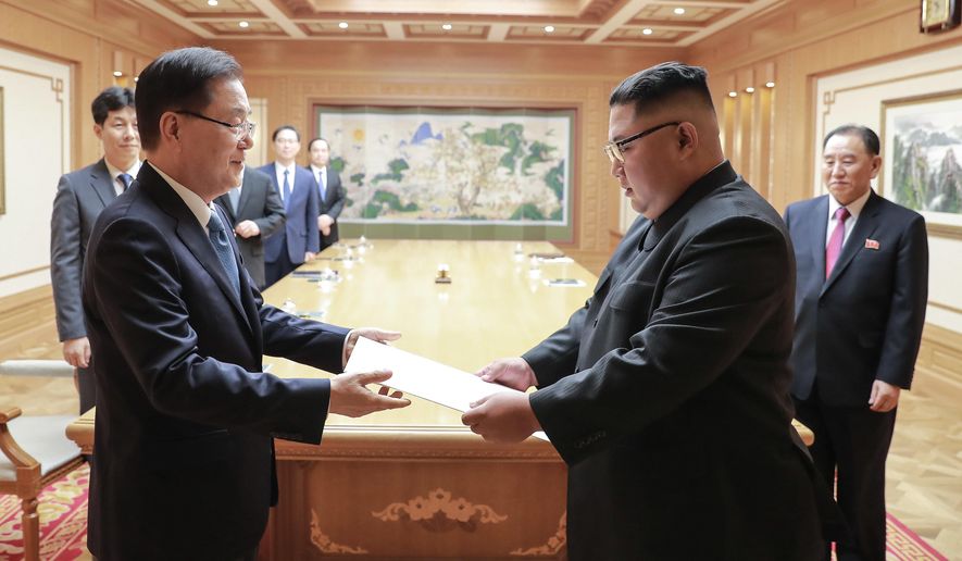In this Wednesday, Sept. 5, 2018, photo provided on Thursday, Sept. 6, 2018, by South Korea Presidential Blue House via Yonhap News Agency, North Korean leader Kim Jong-un receives the letter from South Korean President Moon Jae-in from South Korean National Security Director Chung Eui-yong, left, in Pyongyang, North Korea. (South Korea Presidential Blue House/Yonhap via AP)