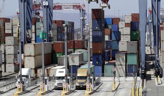In this Aug. 22, 2018, file photo cargo is unload from trucks at the Port of Long Beach in Long Beach, Calif. (AP Photo/Marcio Jose Sanchez, File) **FILE**