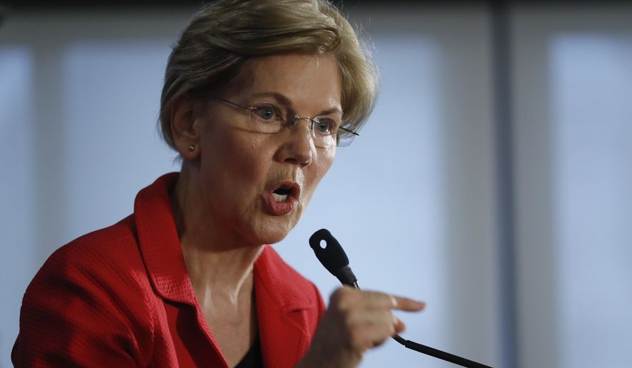 Sen. Elizabeth Warren, D-Mass., gestures while speaking at the National Press Club in Washington, Tuesday, Aug. 21, 2018. Warren wants a lifetime ban on members of Congress from getting hired as lobbyists after they leave public office. She also wants to prohibit lawmakers from owning or trading individual stocks while in office. (AP Photo/Pablo Martinez Monsivais)