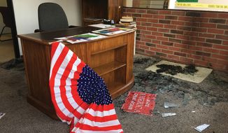 Broken glass and fire damage is shown inside the Albany County Republican Party office following a fire, Thursday, Sept. 6, 2018, in Laramie, Wyo. Authorities say the fire caused minor damage and no injuries and that it is being investigated as arson. (Shannon Broderick/Laramie Boomerang via AP)