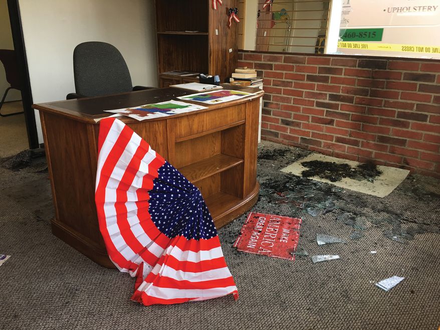 Broken glass and fire damage is shown inside the Albany County Republican Party office following a fire, Thursday, Sept. 6, 2018, in Laramie, Wyo. Authorities say the fire caused minor damage and no injuries and that it is being investigated as arson. (Shannon Broderick/Laramie Boomerang via AP)