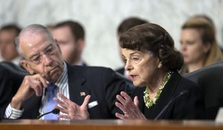 Senate Judiciary Committee Chairman Chuck Grassley, R-Iowa, left, listens to a procedural question from Sen. Dianne Feinstein, D-Calif., the ranking member, as President Donald Trump&#39;s Supreme Court nominee, Brett Kavanaugh, waits to testify before the Senate Judiciary Committee for the third day of his confirmation hearing, on Capitol Hill in Washington, Thursday, Sept. 6, 2018. (AP Photo/J. Scott Applewhite) ** FILE **