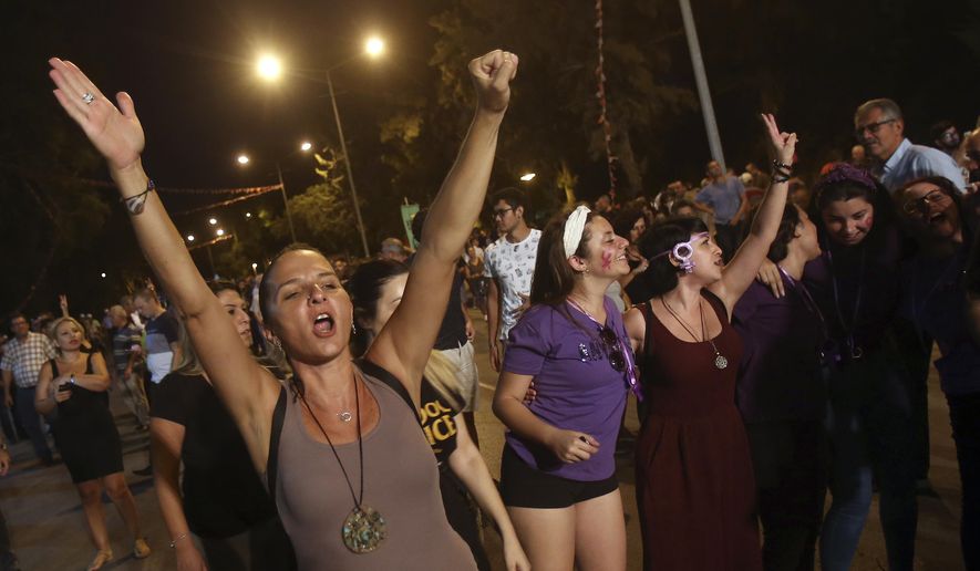 Turkish Cypriot protesters decrying economic hardship brought on by Turkey's currency woes, march through the northern part of ethnically split Cyprus' capital Nicosia on Thursday, Sept. 6, 2018. Some hundreds of Turkish Cypriots marched near the parliament of the breakaway Turkish Cypriot north of the island to demonstrate their disgruntlement over the steep price hikes in fuel, electricity and other goods.(AP Photo/Philippos Christou)