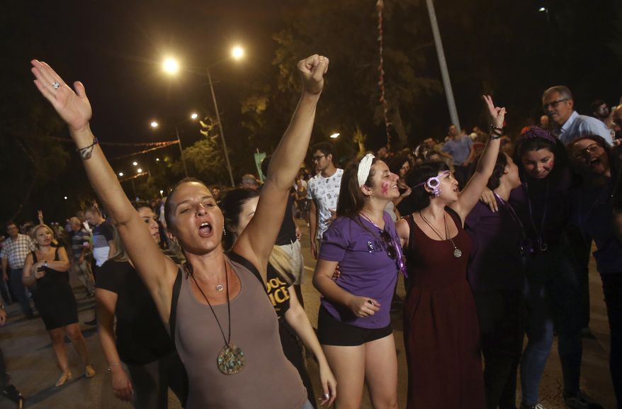 Turkish Cypriot protesters decrying economic hardship brought on by Turkey's currency woes, march through the northern part of ethnically split Cyprus' capital Nicosia on Thursday, Sept. 6, 2018. Some hundreds of Turkish Cypriots marched near the parliament of the breakaway Turkish Cypriot north of the island to demonstrate their disgruntlement over the steep price hikes in fuel, electricity and other goods.(AP Photo/Philippos Christou)