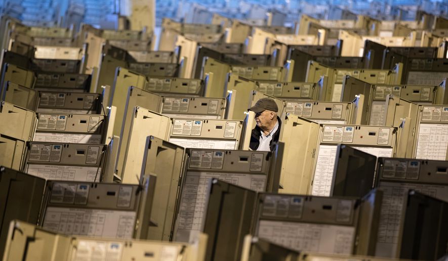 In this Oct. 14, 2016, file photo, a technician works to prepare voting machines to be used in the upcoming presidential election, in Philadelphia. (AP Photo/Matt Rourke, File)