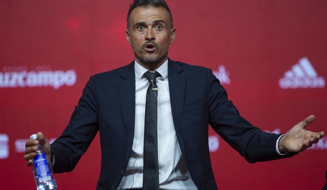 FILE - In this file photo dated Thursday, July 19, 2018, Spanish coach Luis Enrique talks to journalists during his official presentation as Spain new head coach in Las Rozas, outskirts of Madrid. According to Media reports Thursday Sept. 6, 2018, Enrique appears to be taking a hard line to try to get “La Roja” back on track after its recent setbacks, imposing strict new rules for the Spanish team that include a cell-phone ban during meals. (AP Photo/Francisco Seco, FILE)
