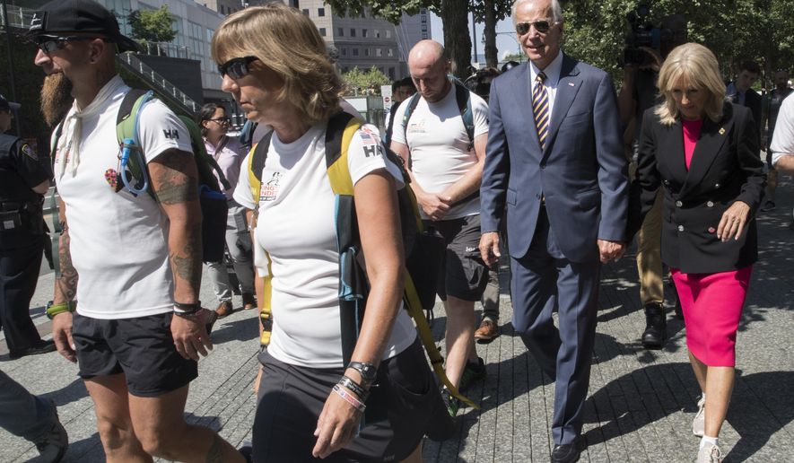 Former Vice President Joe Biden, second from right, and his wife Dr. Jill Biden, walk with members of Walking With The Wounded as they complete the 1,000-mile Walk of America, Thursday, Sept. 6, 2018, in New York. (AP Photo/Mary Altaffer)
