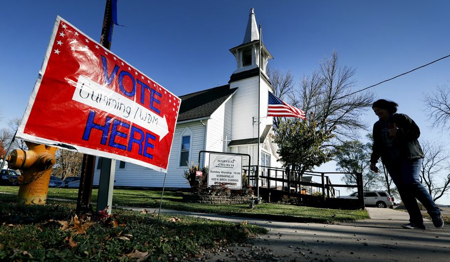 In this Tuesday, Nov. 8, 2016 file photo, a local resident leaves a church after voting in the general election in Cumming, Iowa. Religion&#39;s role in politics and social policies is in the spotlight heading toward the midterm elections, yet relatively few Americans consider it crucial that a candidate be devoutly religious or share their religious beliefs, according to an AP-NORC national poll conducted Aug. 16-20, 2018. (AP Photo/Charlie Neibergall) **FILE**