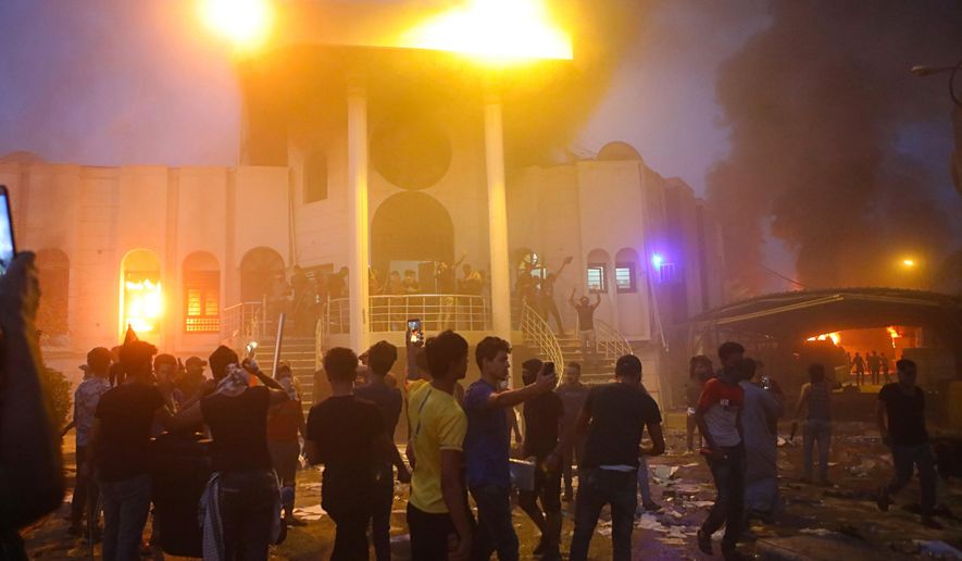 Protesters storm and burn the Iranian consulate building in Basra, 340 miles (550 km) southeast of Baghdad, Iraq, Friday, Sept. 7, 2018. Hundreds of angry protesters in Basra took to the streets on Thursday night. Some clashed with security forces, lobbing Molotov cocktails and setting fire to a government building as well as the offices of Shiite militias. At least three people were shot dead in confrontations with security forces. (AP Photo/Nabil al-Jurani)