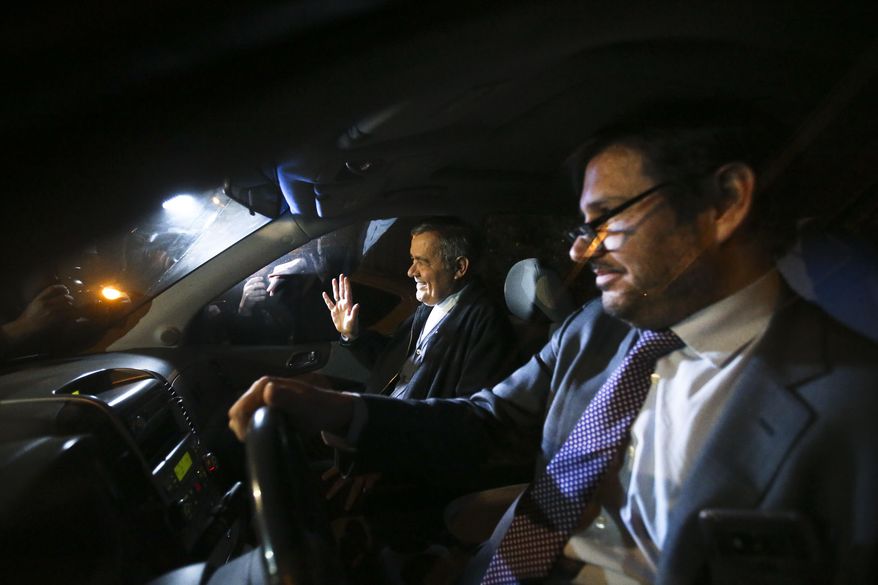 Bishop emeritus Juan Barros waves to the press after leaving the police sex crimes division building in Santiago, Chile. Thursday, Sept. 6, 2018. Prosecutors questioned Barros, who has been accused of covering up the abuses of the country’s most notorious predator priest. (AP Photo/Esteban Felix)