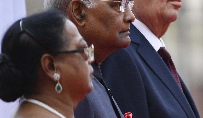 Czech President Milos Zeman, Indian President Ram Nath Kovind and his spouse Savita Kovind, from right, listen to national anthems during a welcoming ceremony at the Prague Castle on Friday, Sept. 7, 2018. Ram Nath Kovind is on his four-day official visit to the Czech Republic. (Michal Kamaryt/CTK via AP)