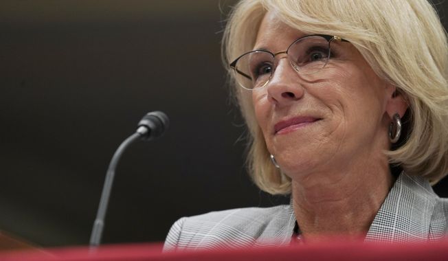 FILE - in this June 5, 2018, file photo, Education Secretary Betsy DeVos pauses as she testifies on Capitol Hill in Washington. Preliminary data obtained by The Associated Press show the Trump administration is granting only partial loan forgiveness to the vast majority of students it approves for help because of fraud by for-profit colleges. The data demonstrate the impact of DeVos’ new policy of tiered relief, in which students swindled by for-profit schools are compensated based on their earnings after the program. (AP Photo/Carolyn Kaster, File)