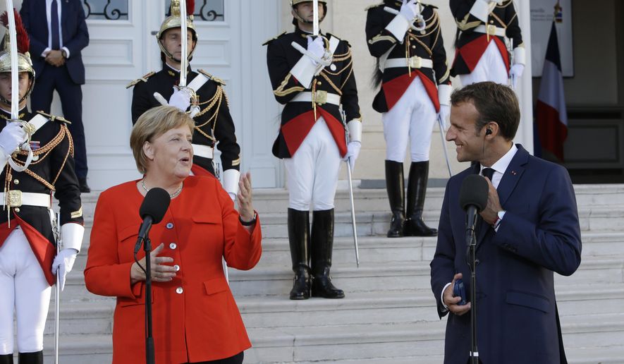 German Chancellor Angela Merkel, left, and French President Emmanuel Macron make deceleration to the media prior to a meeting at the Pharo Palace in Marseille, southern France, Friday, Sept. 7, 2018. German Chancellor Angela Merkel is in Marseille for talks on European issues such as migration and eurozone reform. (AP Photo/Claude Paris)