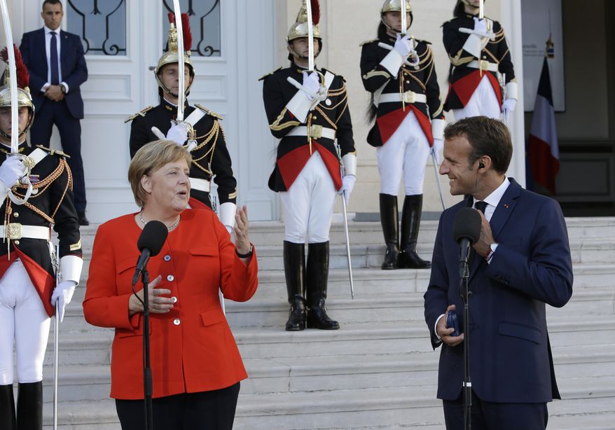 German Chancellor Angela Merkel, left, and French President Emmanuel Macron make deceleration to the media prior to a meeting at the Pharo Palace in Marseille, southern France, Friday, Sept. 7, 2018. German Chancellor Angela Merkel is in Marseille for talks on European issues such as migration and eurozone reform. (AP Photo/Claude Paris)