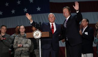 Vice President Mike Pence joins Sen. Dean Heller, R-Nev, on stage in a hanger at Nellis Air Force Base in Las Vegas, Friday, Sept. 7, 2018. (Steve Marcus/Las Vegas Sun via AP)
