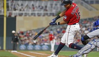 Minnesota Twins&#39; Ehire Adrianza hits a two-run single off Kansas City Royals pitcher Heath Fillmyer during the second inning of a baseball game Friday, Sept. 7, 2018, in Minneapolis. (AP Photo/Jim Mone)
