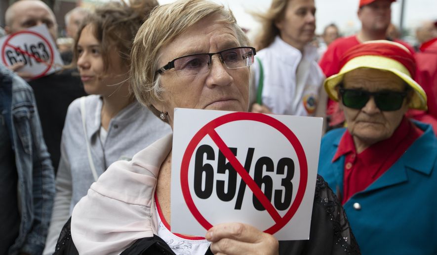 FILE - in this file photo taken on Tuesday, Aug. 21, 2018, a woman holds a poster showing the raise in the pension ages from 60 to 65 for men and to 63 for women, up from 55 during a rally protesting retirement age hikes in front of the Russian State Duma, the Lower House of the Russian Parliament in Moscow, Russia. The hike in the retirement age was long overdue in Russia. The country&#39;s ageing population and a shrinking workforce means that the government spends more and more on pensions every year. This year alone, Russia is earmarking 3.3 trillion rubles ($48 billion) on old-age pension, which is even higher than Russia&#39;s defense spending. (AP Photo/Alexander Zemlianichenko)