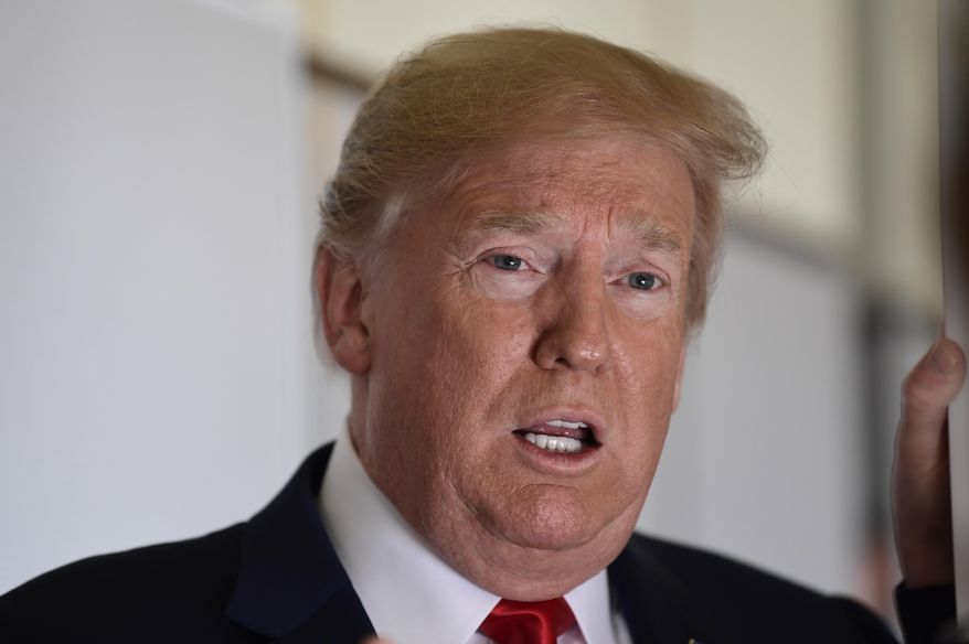 President Donald Trump talks to reporters while in flight from Billings, Mont., to Fargo, N.D., Friday, Sept. 7, 2018. (AP Photo/Susan Walsh)